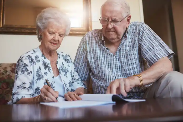 Happy retired couple reviewing their timeshare paperwork